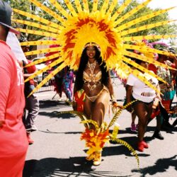 Dancer in radiant yellow sunburst carnival costume