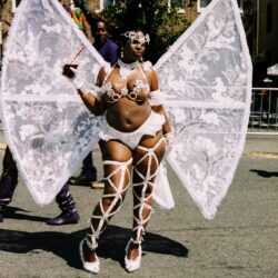 Performer in white lace carnival costume with wings