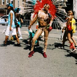 Carnival performer with red feathered headdress