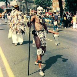 Parade performer in tribal face paint and costume