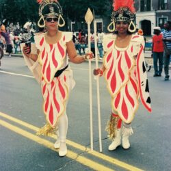 Two women in red feathered carnival costumes