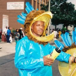Person in blue bird costume at parade