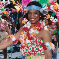 Smiling woman in colorful carnival floral costume