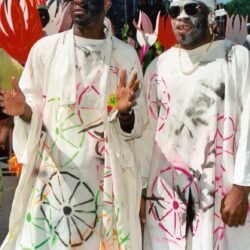Two performers in painted white robes