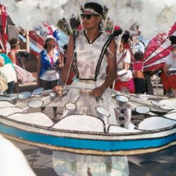 Performer in large circular drum-like carnival costume