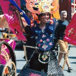 Person in elaborate colorful carnival costume smiling