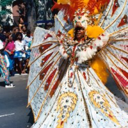 Parade performer in ornate yellow carnival costume