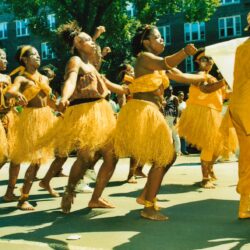 Group of dancers in yellow costumes at parade