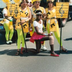 Parade performers in yellow musical-note costumes