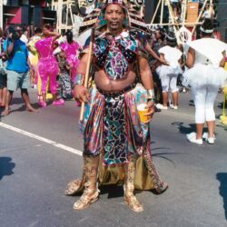 Person in vibrant carnival costume with feathered headdress