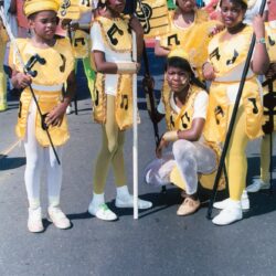 Young performers in yellow musical parade costumes