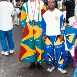 Two men in colorful St. Lucia flag outfits