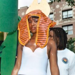 Woman wearing Egyptian headdress and white leotard