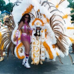 Two people in white and gold carnival costumes