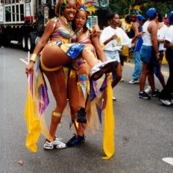 Two women in colorful carnival costumes posing together