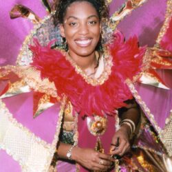 Smiling woman in pink feathered carnival costume