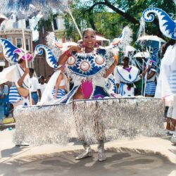 Smiling woman in elaborate blue and silver costume