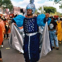 Person in blue sequined costume at parade