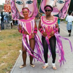 Two women in pink carnival costumes