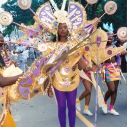 Parade performer in ornate purple and gold costume