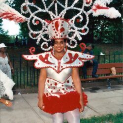 Smiling woman in red-and-white carnival costume