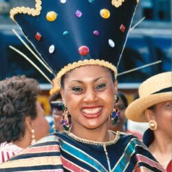 Smiling woman in colorful jeweled carnival headdress