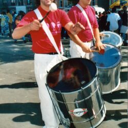 Two drummers in red shirts at parade
