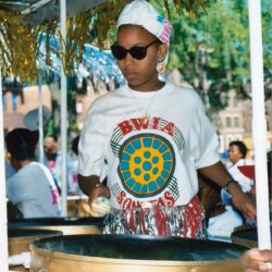 Woman playing steelpan drums at festival
