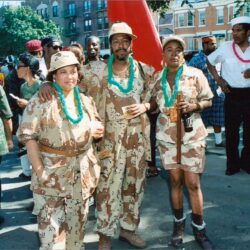 People in matching desert camouflage outfits at parade
