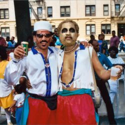 Two men in colorful costumes at parade