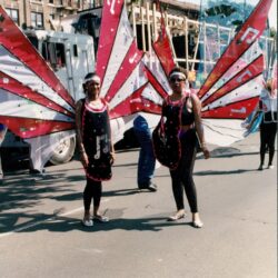 Two women in red butterfly parade costumes
