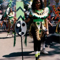 Parade performer in green carnival costume