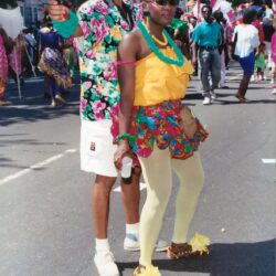 Two people in colorful costumes at parade