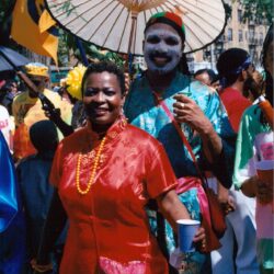 Woman in red dress with painted performer