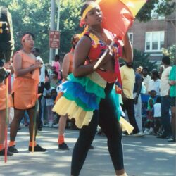 Colorful parade dancer twirling vibrant flag