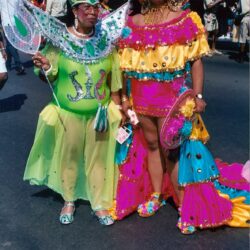 Two people in colorful carnival parade costumes