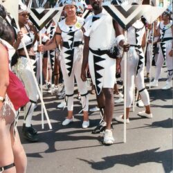 Parade performers in black-and-white geometric costumes