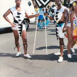 Two performers in black-and-white parade costumes
