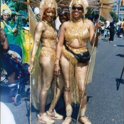 Three women in gold carnival costumes