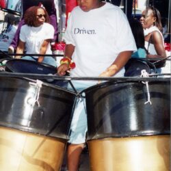 Young woman playing steel drums in parade