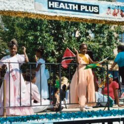Girls in formal dresses on Health Plus float