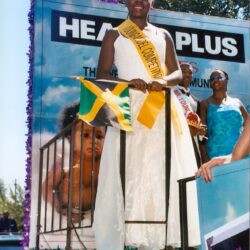 Beauty queen holding Jamaican flag on float