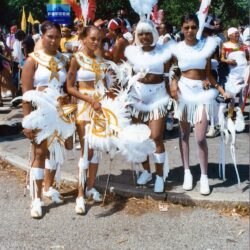 Four women in white feathered carnival costumes