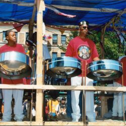 Two musicians playing steel drums at festival