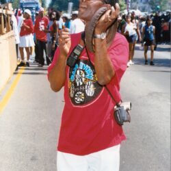 Man listening to conch shell at street festival