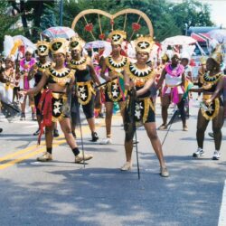 Carnival dancers in gold and black costumes