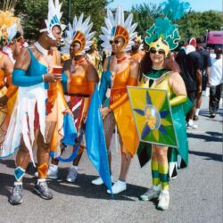Colorful carnival performers in feathered costumes