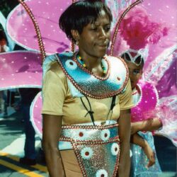 Person in beaded costume with large pink wings