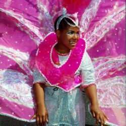 Smiling child in pink carnival costume
