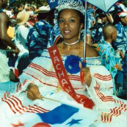Carnival queen in white dress holding Panamanian flag